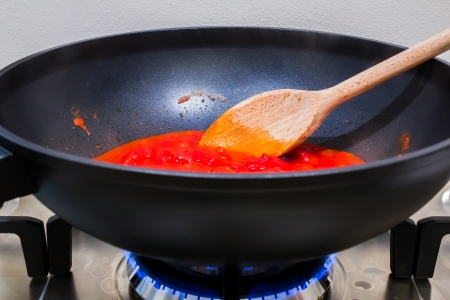 cooking a tomato sauce for tipical italian pasta or pizzaの写真素材