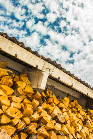 pile of wood down the roof of a hut in the italian alps