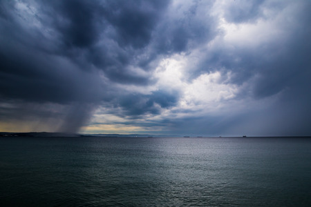 The rain on the sea in front of the cityの写真素材