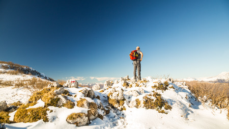 man looking to the italian alps in a winter dayの写真素材
