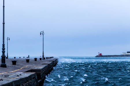 a windy winter afternoon at the port of an italian cityの写真素材