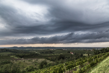 a storm is growin up over the fields of italyの写真素材