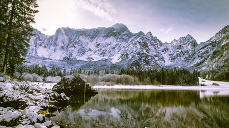 First snow of the winter at a lake in the italian alpsの写真素材
