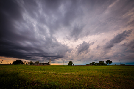 a storm is growin up over the fields of italyの写真素材
