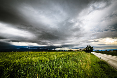 a storm is growin up over the fields of italyの写真素材