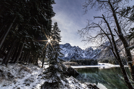 First snow of the winter at a lake in the italian alpsの写真素材