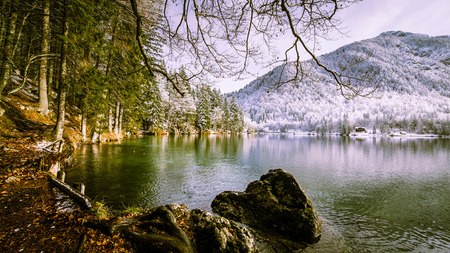 First snow of the winter at a lake in the italian alpsの写真素材