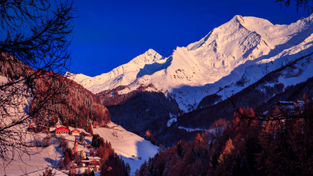 Sun goes down in the alpine valleyの写真素材