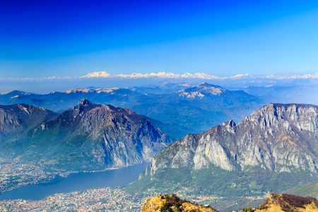 The lake of Como with the city of Lecco and the mountains behind in a spring dayの写真素材