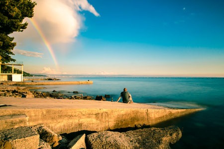 A spring storm with a colorful rainbow in the gulf of Triesteの写真素材