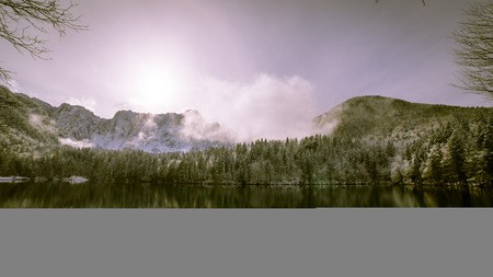 First snow of the winter at a lake in the italian alpsの写真素材