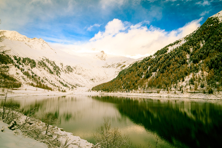 a lake in the winter in the italian alpsの写真素材