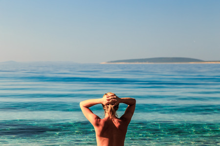 A beautiful blonde girl relaxing in the croatian seaの写真素材