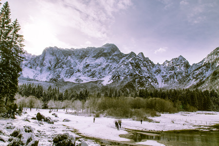 First snow of the winter at a lake in the italian alpsの写真素材