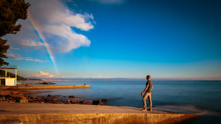 A spring storm with a colorful rainbow in the gulf of Triesteの写真素材