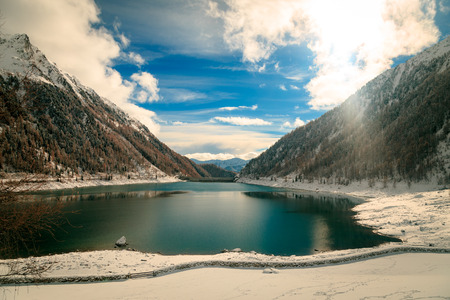 an artificial lake in the italian alps in a winter dayの写真素材