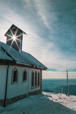 A church on the top of italian alps in a cold winter dayの写真素材