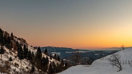 Sunset in the hills between Slovenia and Italy in a freezing winter dayの写真素材