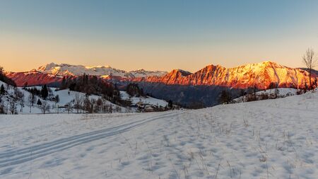 Sunset in the mountains between Slovenia and Italy in a freezing winter dayの写真素材