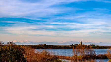 The ancient Sanctuary of Barbana with snowy mountains in the background