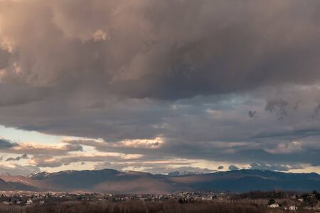 The sun goes behind the clouds over the countryside of Udine,  Friuli-Venezia Giulia, Italy