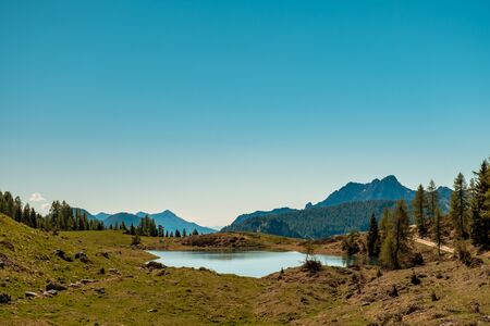 May sunny day at the lake in the alps of Friuli-Venezia Giulia, Italyの写真素材