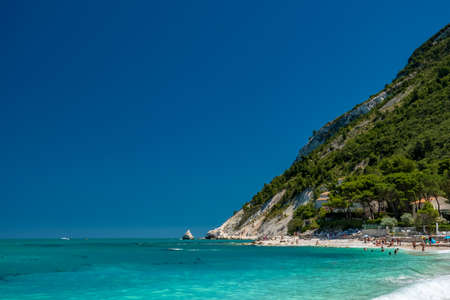 The bay of Portonovo with the Conero mount in the background in a beautiful summer dayの写真素材
