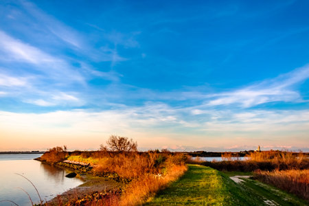 Sun goes down on the lagoon of Grado in a spring day