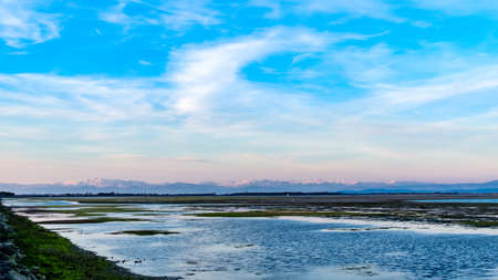 Sun goes down on the lagoon of Grado in a spring dayの写真素材