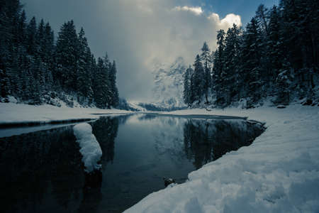 Snow and sun in the same day at the Braies Lake, Trentino Alto-Adige, Italyの写真素材