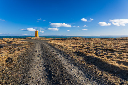 Lighthouse on the coast of iceland in a cold march dayの写真素材