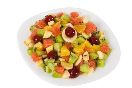 Colorful fruit salad isolated on whiteの写真素材