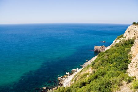 Sea, the blue sky and mountainsの写真素材