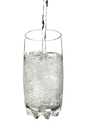 Water poured into a glass isolated on whiteの写真素材