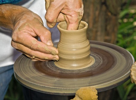 Potter working clay on potter's wheelの写真素材