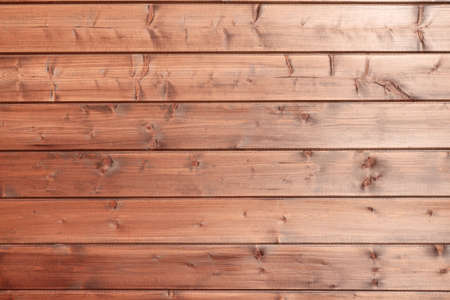 The texture of the wall made of wooden boards covered with brown paintの写真素材
