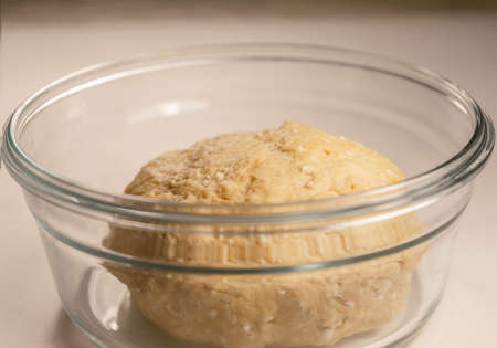 Cottage cheese dough in a glass dish on the tableの写真素材
