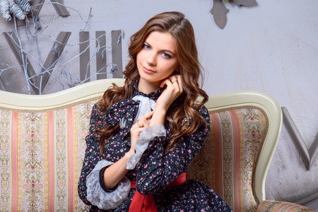 Portrait of a man and a woman near the Christmas tree. The husband embraces his wife, standing next to the tree.の写真素材