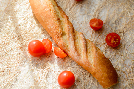 Healthy Breakfast - homemade bread and tomatoes on the tableの写真素材