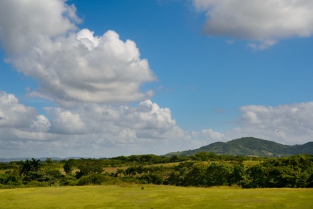 View the beautiful landscape of rocky cliffs and green hills in Cubaの写真素材