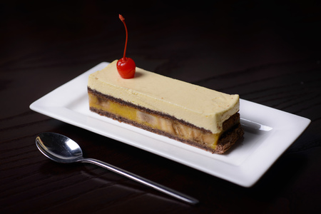 banana cake cakes on a white plate against a dark tableの写真素材