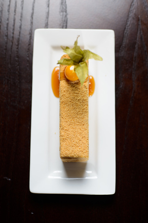 Cake Napoleon of puff pastry with sour cream on a plate closeup.on dark tableの写真素材