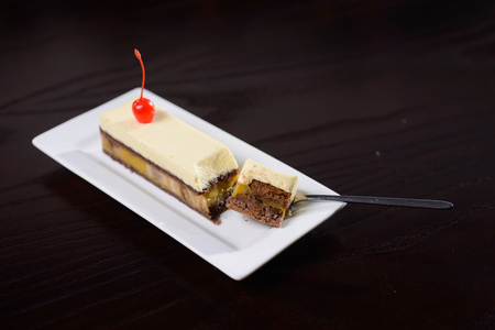 banana cake cakes on a white plate against a dark table