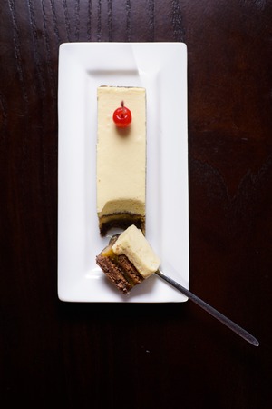 banana cake cakes on a white plate against a dark tableの写真素材