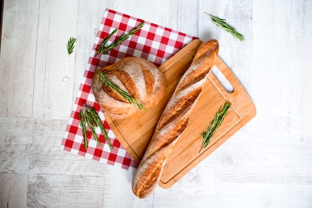 freshly baked bread. Different types of bread and rolls on Board from the top.の写真素材