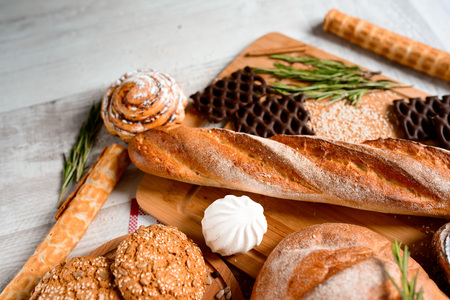 freshly baked bread. Different types of bread and rolls on Board from the top.の写真素材