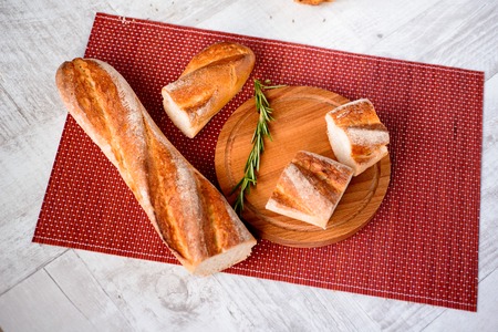freshly baked bread. Different types of bread and rolls on Board from the top.の写真素材