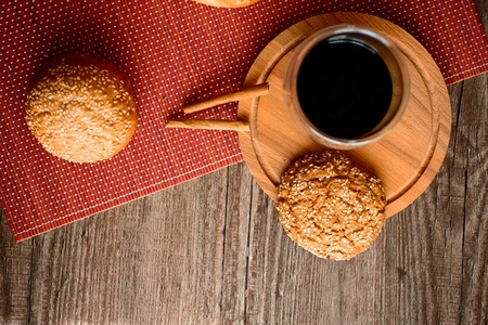 Fresh bread, cookies and coffee on wooden table.の写真素材
