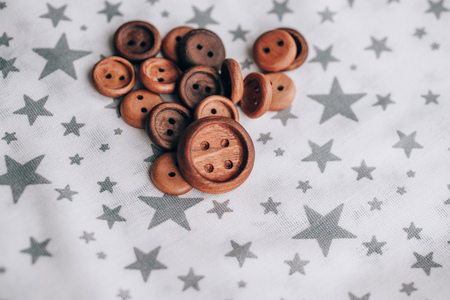 handmade wooden buttons on beautiful cotton fabric in grey stars