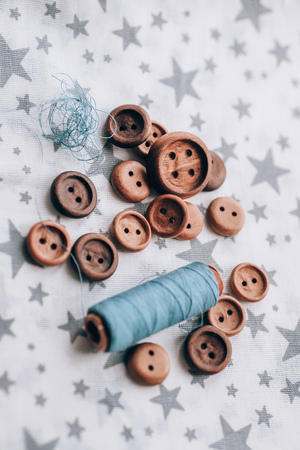 wooden buttons handmade in beautiful cotton fabrics in grey stars , reels of thread